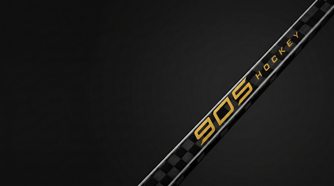 Gold 905 Hockey logo on a black carbon stick shaft